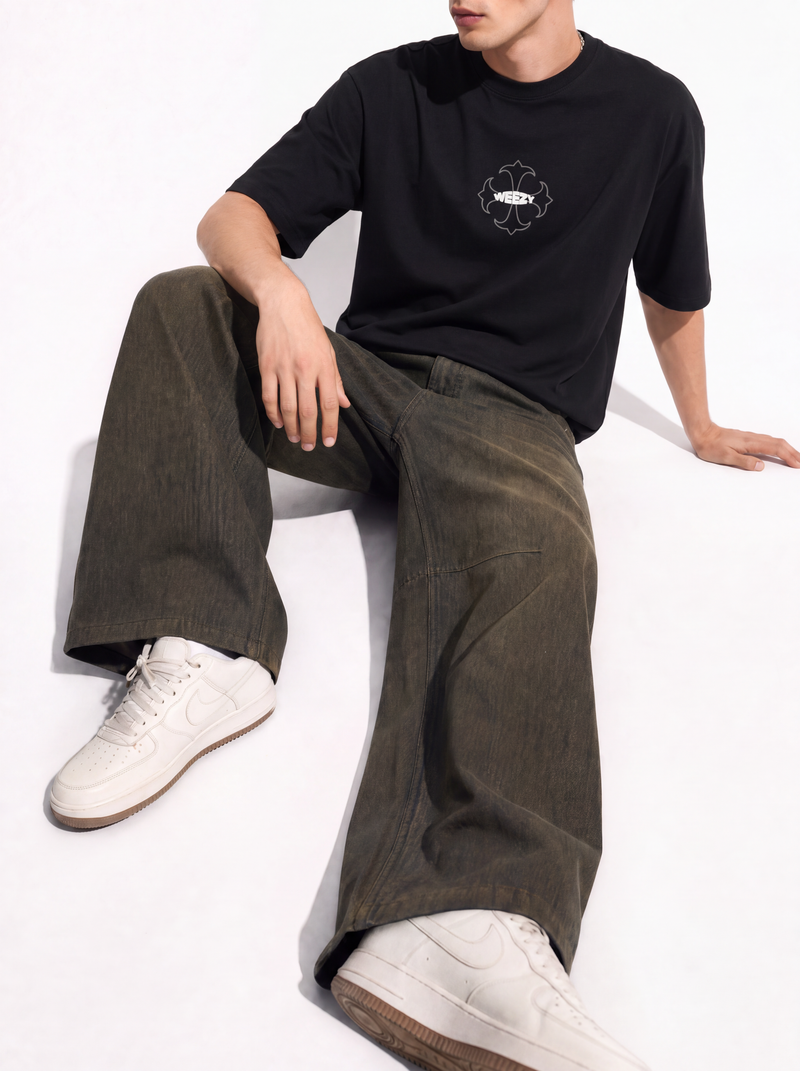 Man in black graphic tee with wide-leg jeans — shop Weezy baggy and wide-leg jeans for men